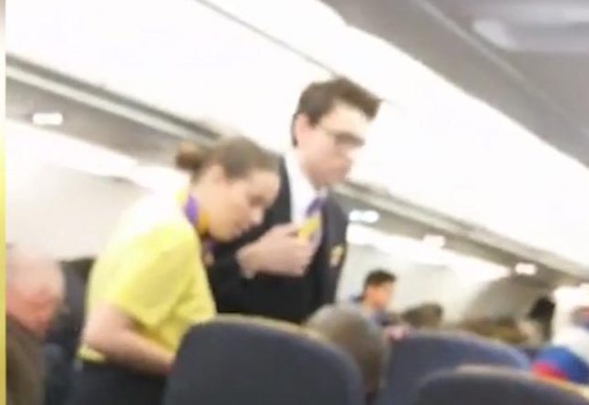 Flight attendants try to calm the pair down 