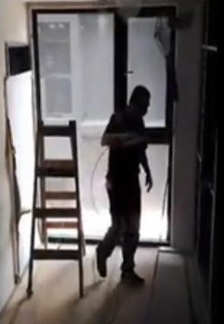  The video at first shows the workman turning his back to the ladder