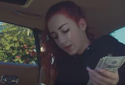  Another scene in the video sees the 13-year-old holding a wad of cash