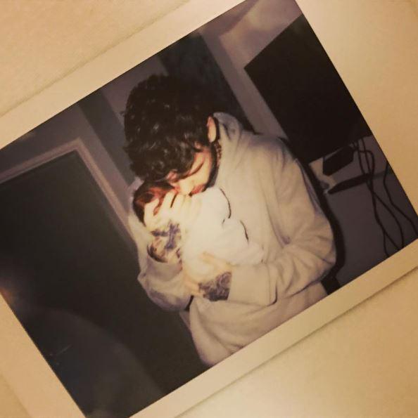  Cheryl shared this picture of boyfriend Liam Payne cradling their newborn son on Saturday night