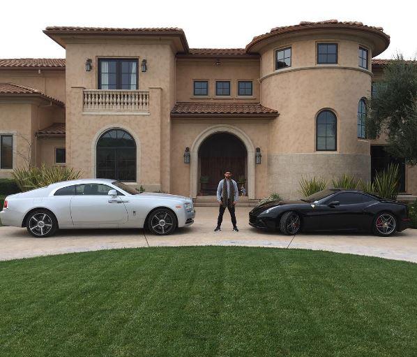 Amir Khan stands proudly with this cars outside his mansion