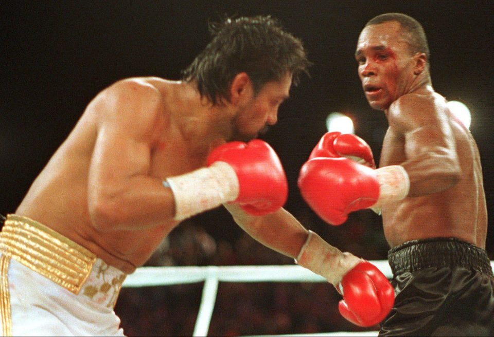 Roberto Duran, left, takes aim at Sugar Ray Leonard, with blood running down his face