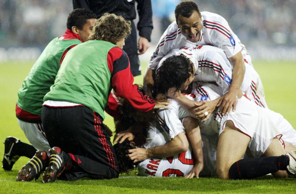 AC Milan players celebrate after Massimo Ambrosini's late goal against PSV Eindhoven