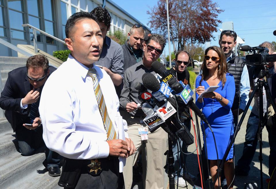  A Vallejo police officer speaks to press. Huskins is now suing the city and two cops after she was accused of staging the crime