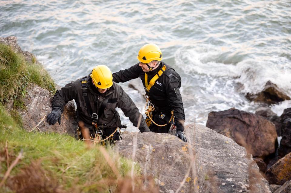  Police officers in protective gear are seen checking the coastline around Anstey's Cove in Torquay after Rose went missing