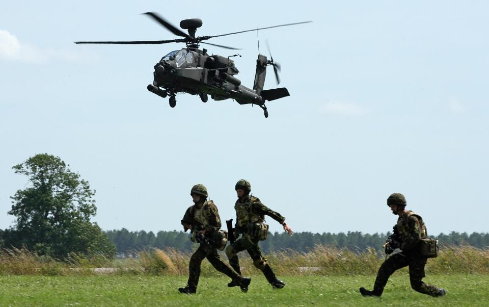  An AH-64 Apache helicopter takes part in a mission rehearsal exercise by the 3 Commando Brigade (Royal Marines) on Salisbury Plains