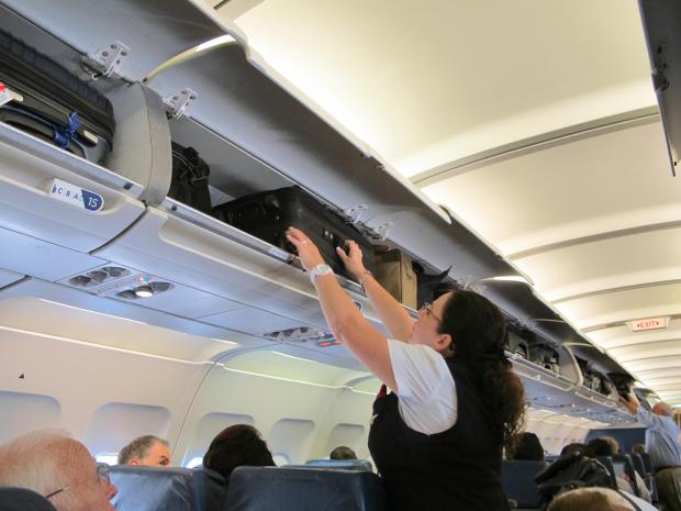 A woman is suing an airline after a suitcase fell out of a plane’s overhead compartment and landed on her head