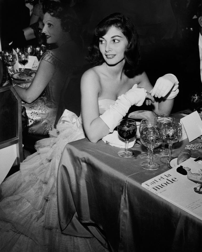  Actress Pier Agnelli, wearing a strapless gown and gloves,pictured at the Franco-American ball at the Waldorf