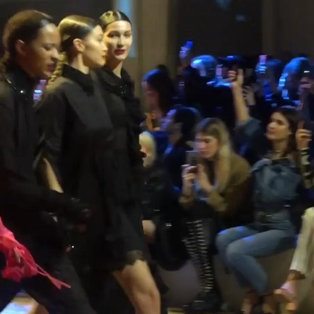  Bella Hadid couldn't help but glance awkwardly at sister Gigi as she walked past The Weeknd on the catwalk