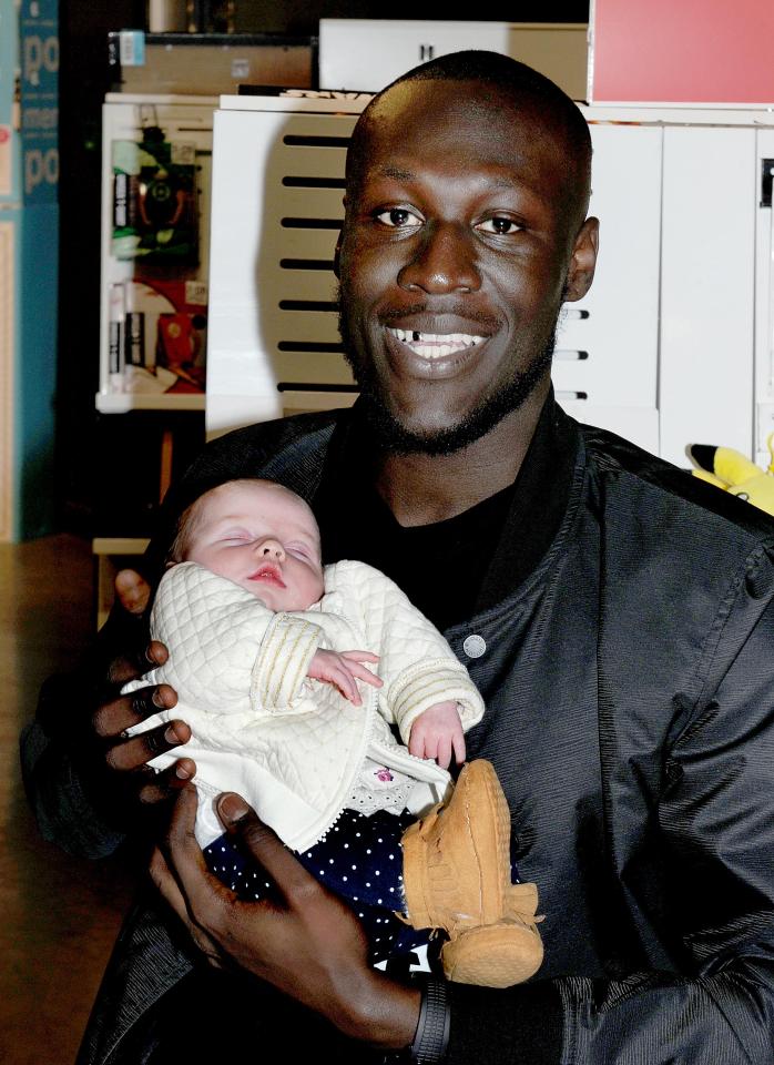  Stormzy cuddled an adorable baby at his album signing