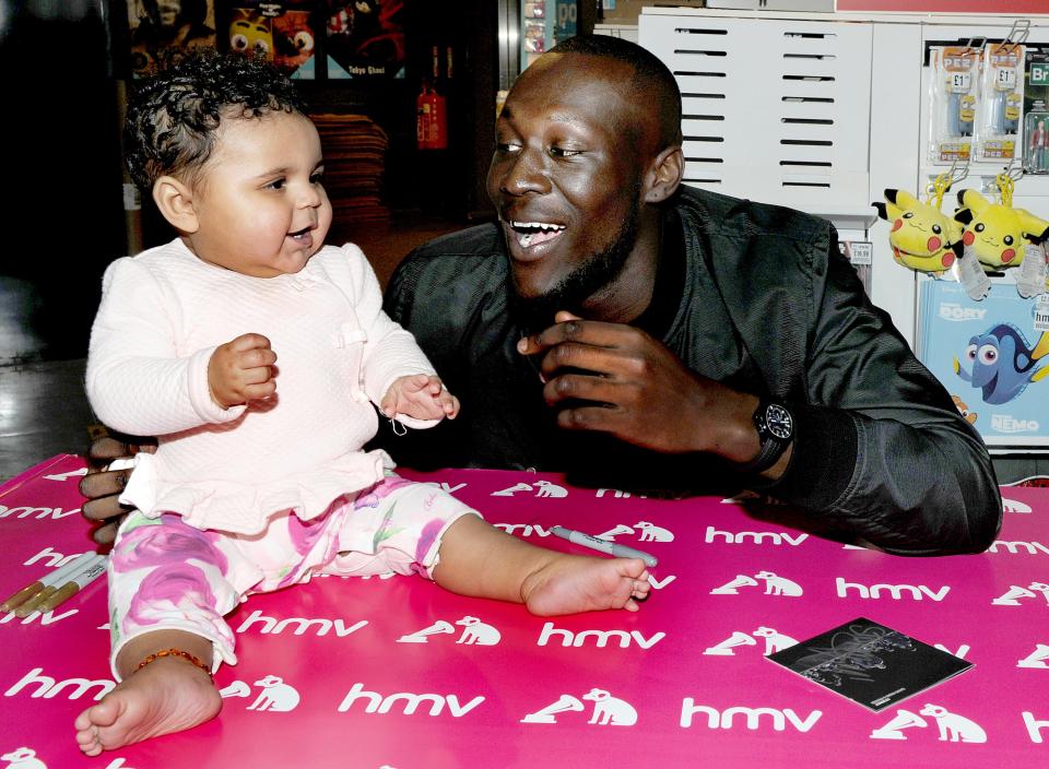  He melted hearts as he larked about with another infant on the signing table