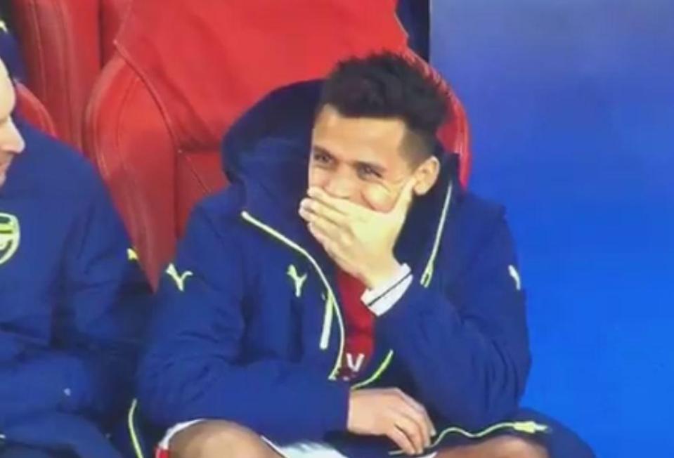 Sanchez tries to stifle a grin on the Gunners bench