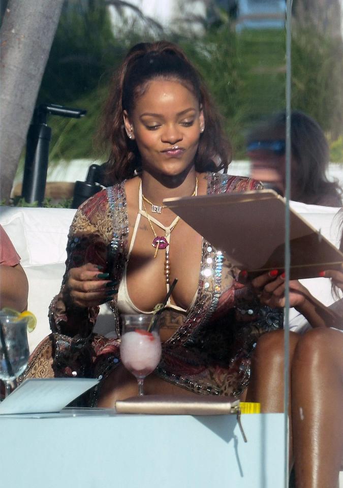  Rihanna looked pretty pleased with herself as she browsed the cocktail menu