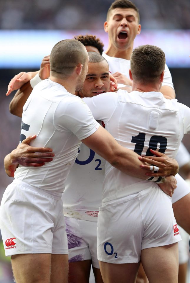 After scoring the try, Jonathan Joseph is mobbed by his team-mates in the clash against Scotland