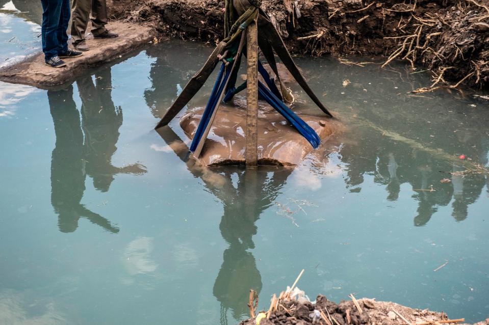 The huge statue is gently raised from a watery grave. It lay undisturbed for thousands of years