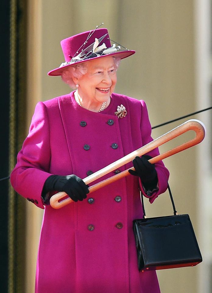  The Queen looks delighted as she gets to grips with Commonwealth Games relay baton