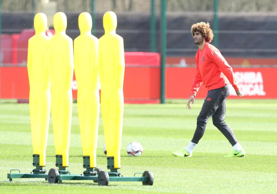  Marouane Fellaini lines up next to some training dummies