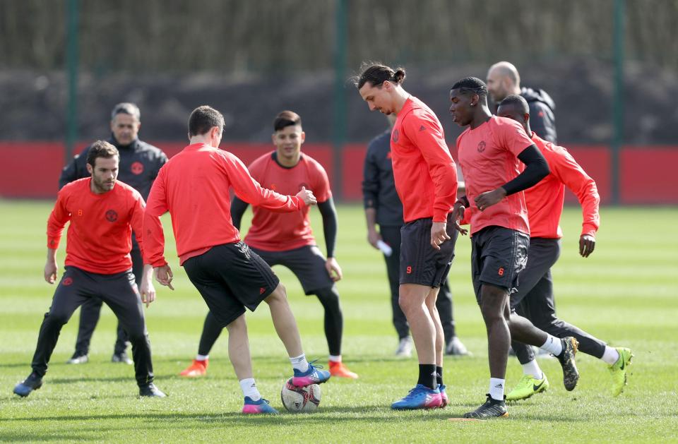  Zlatan Ibrahimovic watches Ander Herrera on the ball