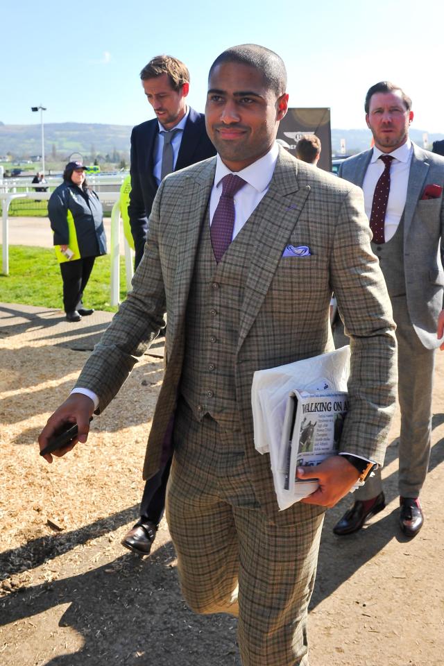 Glen Johnson walks into the grandstand at Cheltenham in a sharp-looking three-piece tweed suit