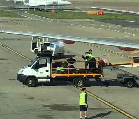 The bags were thrown from the conveyor belt to the back of the truck