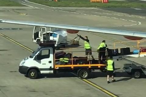 The baggage handlers were unloading an easyJet plane in September when they were spotted