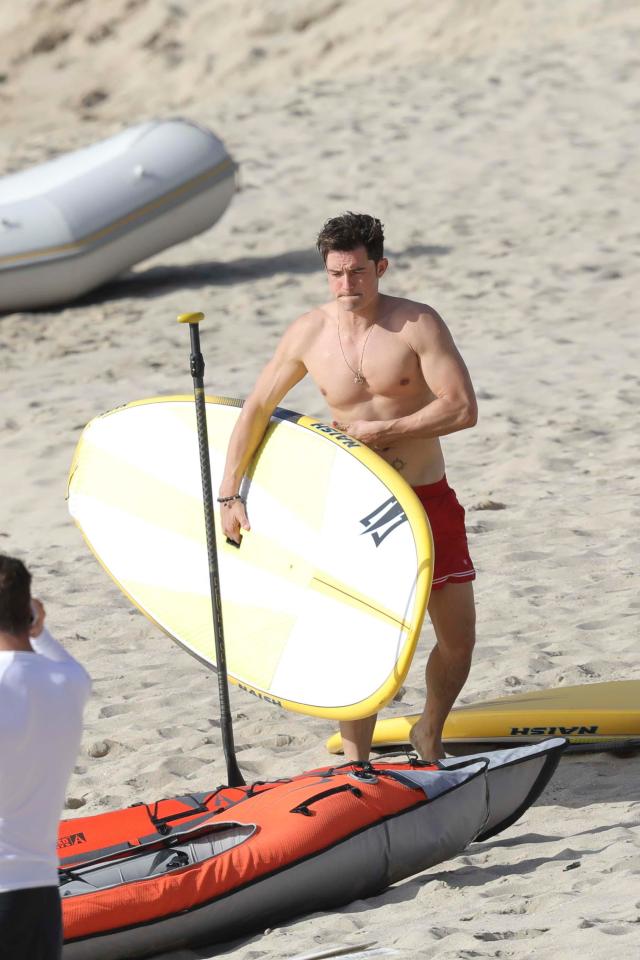  The hunk showed off his muscles as he headed out to sea