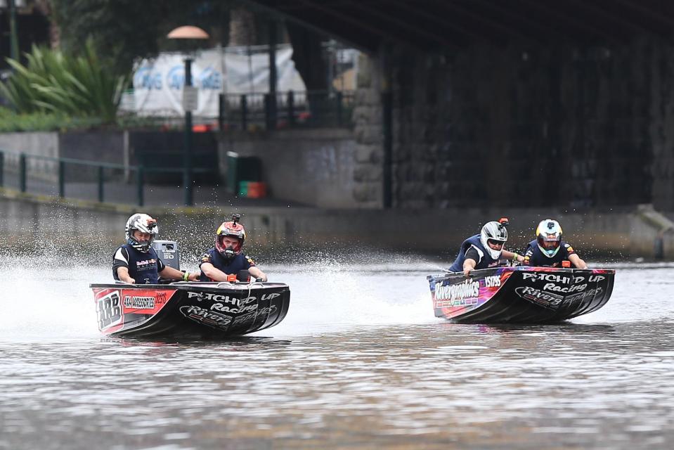 Daniel Ricciardo races Max Verstappen on the Yarra River