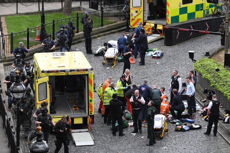  Emergency services treat two people – thought to be the attacker and injured cop – outside Parliament following the attack