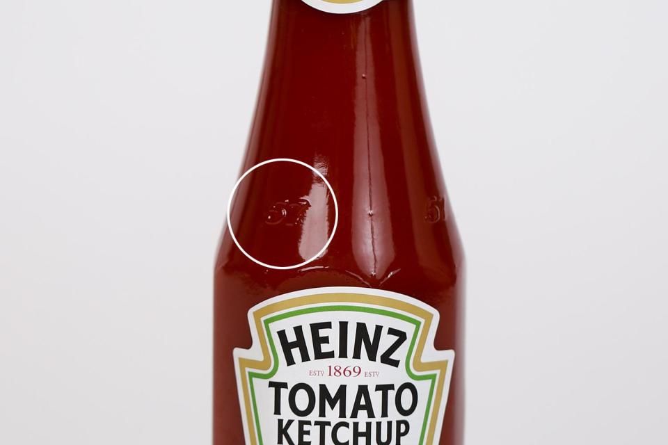  There's no need to mindlessly bash on the  bottom of the bottle. It turns out that tapping the 57 on the neck is the perfect way to extract the precious sauce