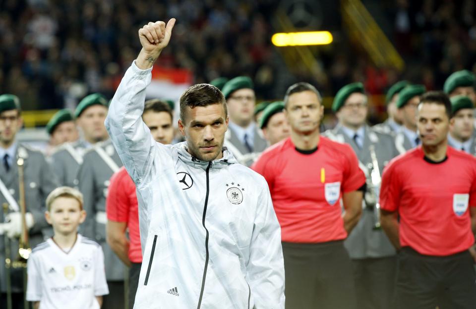 Podolski gives the crowd a thumbs up before kick-off