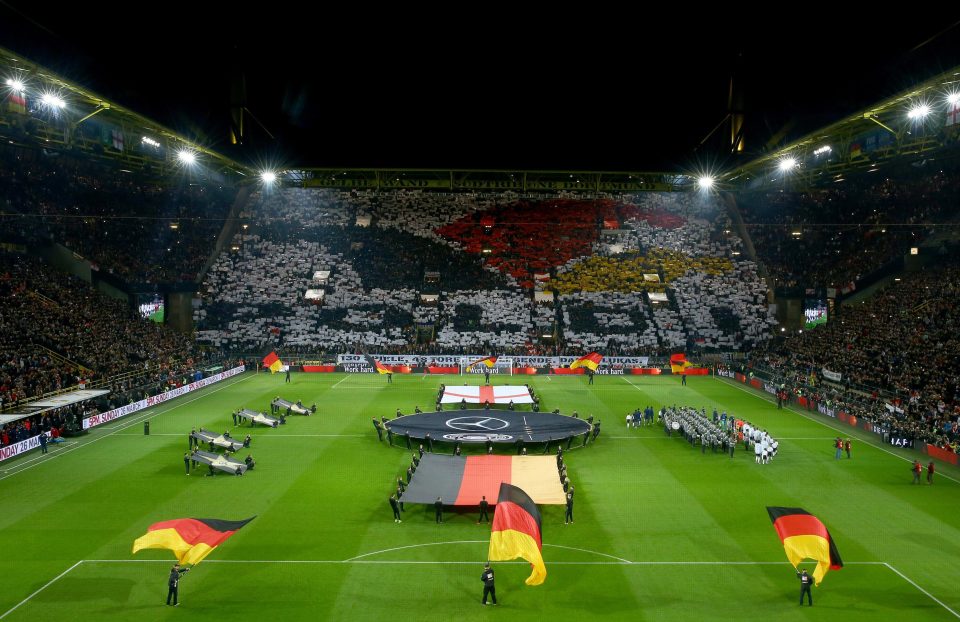 The Yellow Wall celebrate Podolski on his 130th cap