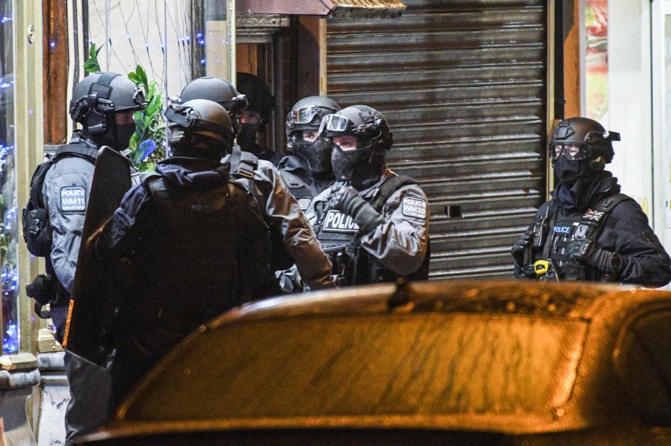  Armed cops outside a flat in Birmingham which was raided