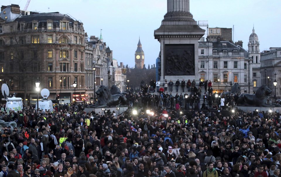  People gather during a candlelit vigil at Trafalgar Square on March 23