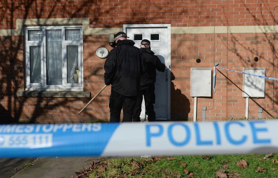  Officers search the area and cordon off a property in Birmingham