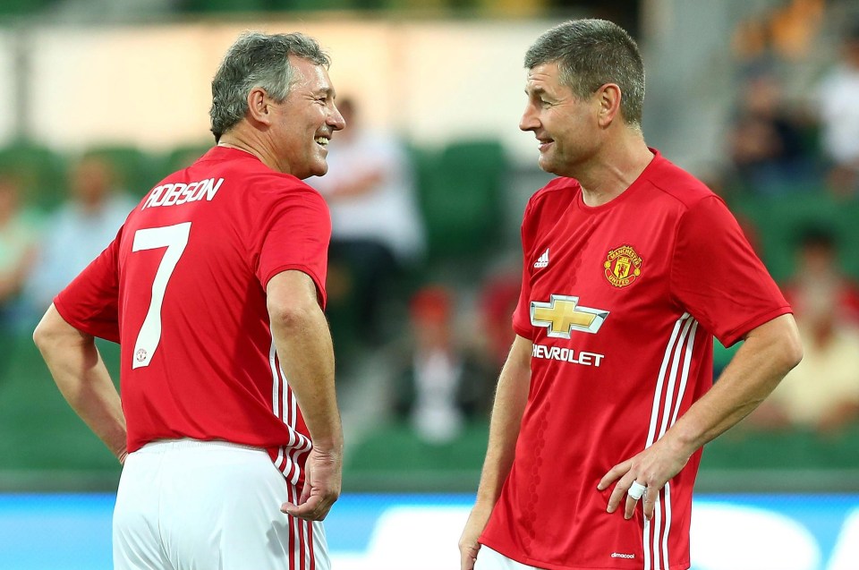 Denis Irwin and Bryan Robson chat before the match in honour of Dylan Tombides