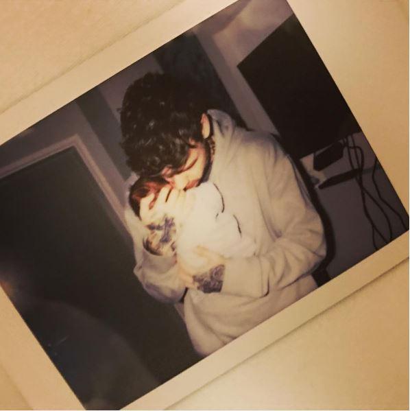  The couple shared a picture of new dad Liam Payne cradling the tot