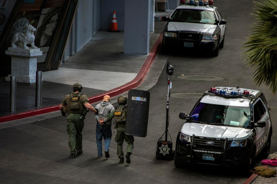  The man is led away by cops