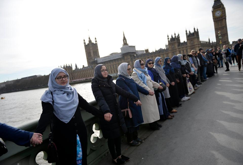  They stood side by side with many wearing traditional Islamic attire and blue items to symbolise peace