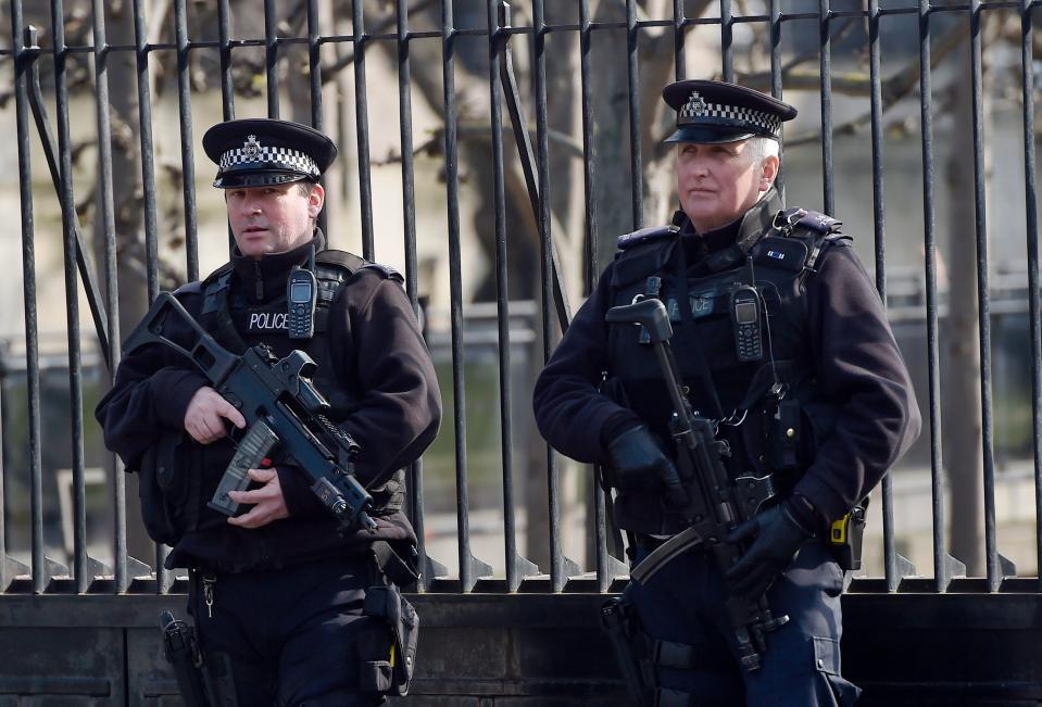  Armed police stand at the gates of The Houses of Parliament in central London