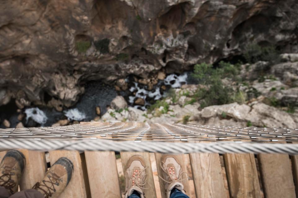 The three-foot wide path is pinned to the side of a rock face overlooking a gorge in Malaga