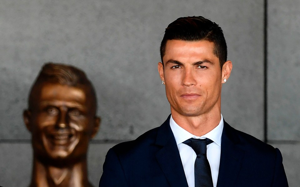 Cristiano Ronaldo keeps his distance from the bronze bust supposed to look like him