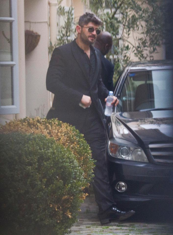  Fadi Fawaz leaves his home dressed in black