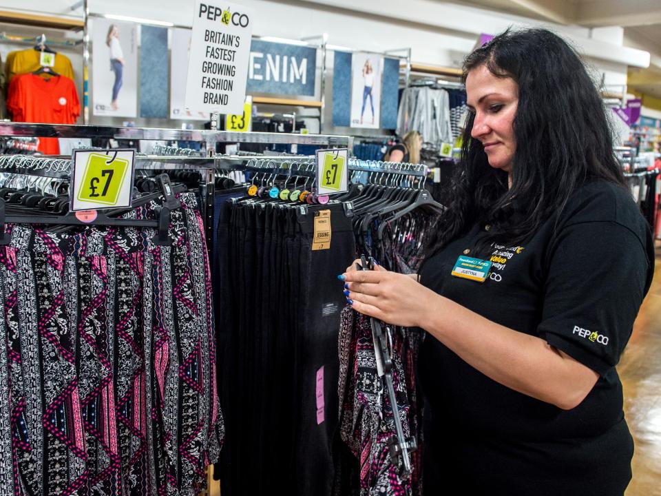  Poundland staff member Justyna puts out new stock with the Pep&Co summer range at the Woolwich store in south east London