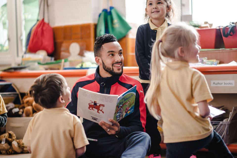 Arsenal and England forward Theo Walcott reads to the kids