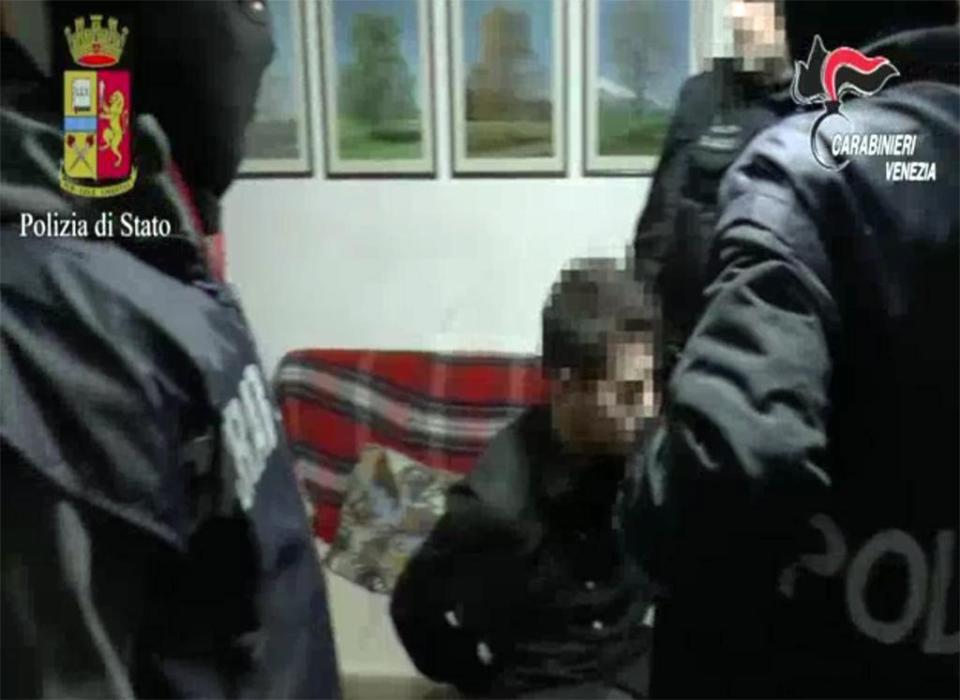  An image shows cops arresting one of the suspected jihadis in an overnight anti-terror sweep in Venice