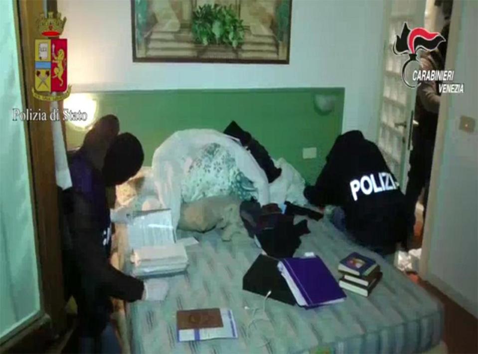  Cops search the room of one of the men who was living in central Venice - a city visited by millions of tourists from all over the world