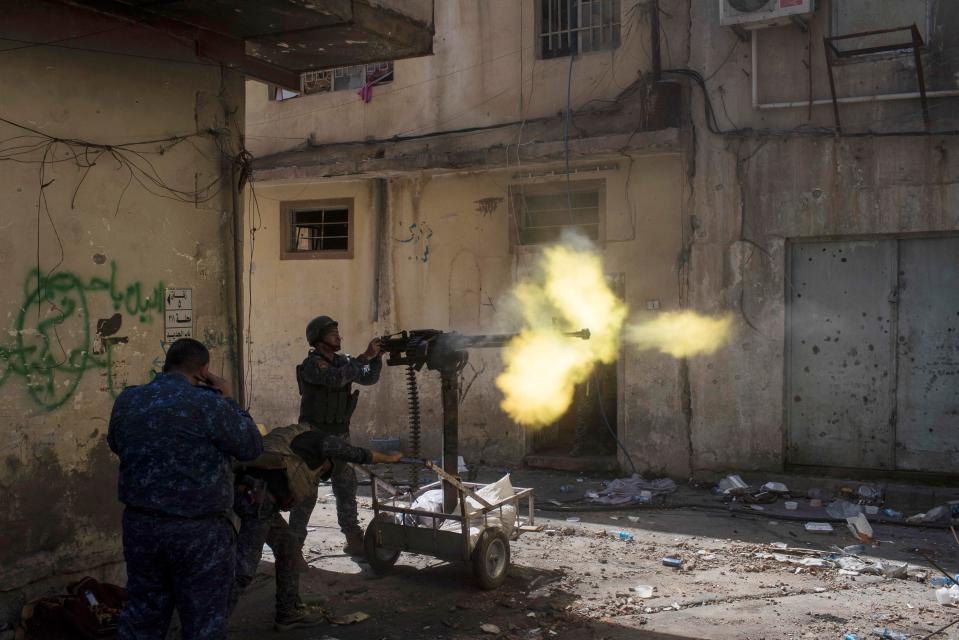  ISIS has lost thousands of troops in fighting in Iraq. Pictured, a federal policeman fire towards Islamic State positions in Mosul yesterday