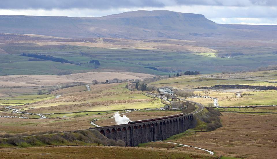 The locomotive snakes its way through the rolling countryside 