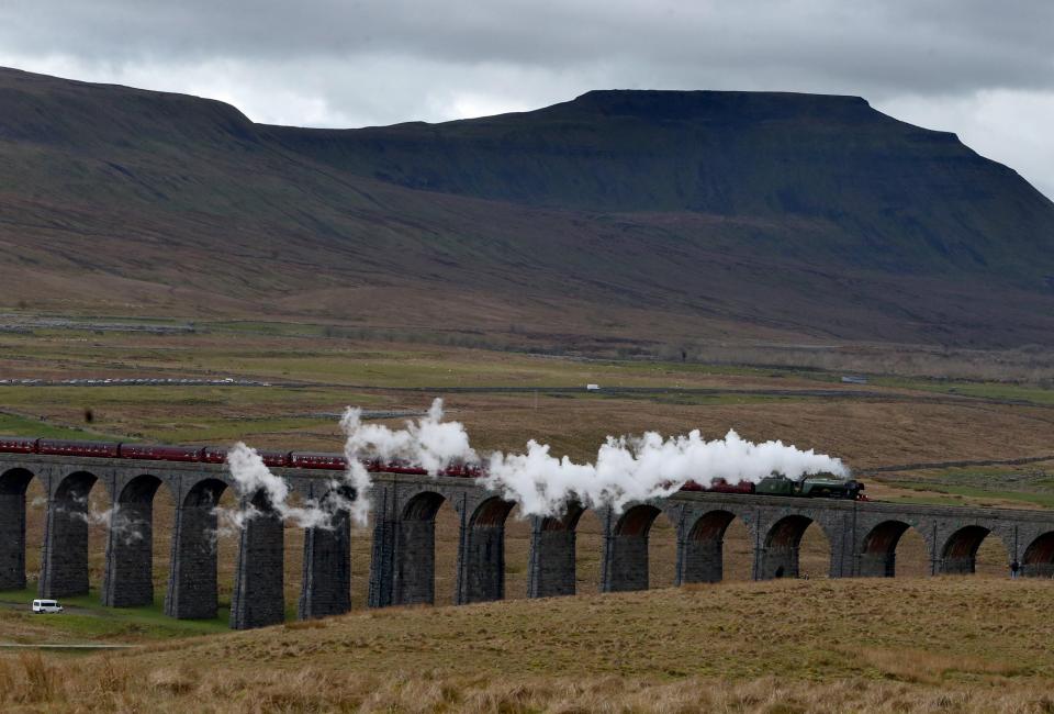 The famous locomotive makes its way over the Ribblehead Viaduct, which is 104ft high and has 24 arches