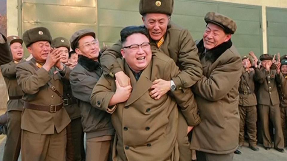 A general jumps with joy behind a equally ecstatic Kim Jong-un